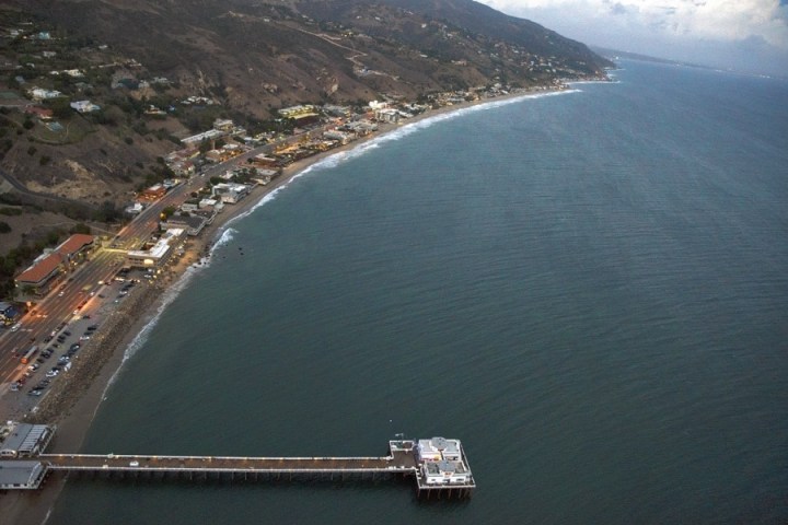 a large body of water with a mountain in the background